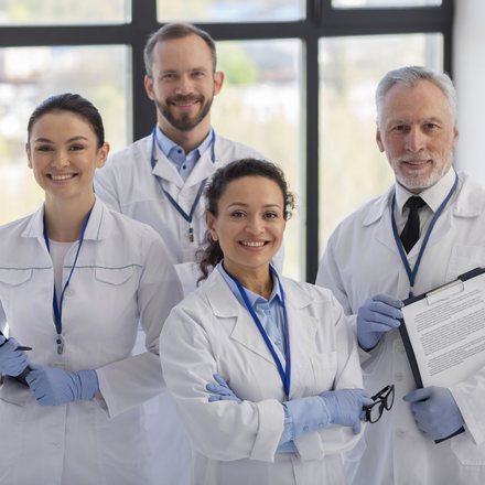 Smiling medical team in white coats