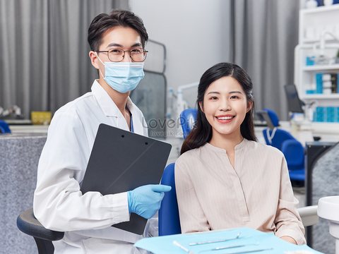 Doctor and patient smiling together at a clinic checkup