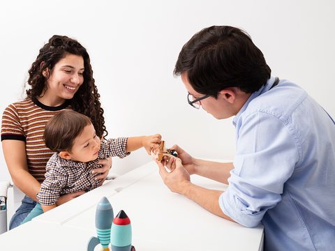 Mother and toddler visiting a friendly doctor
