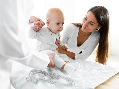 Mother smiling with her baby during a health visit