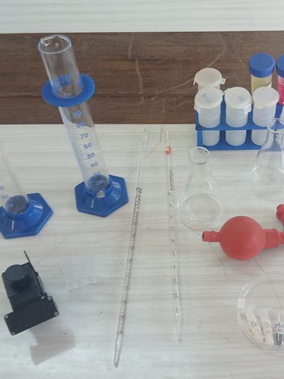 Measuring cylinders, test tubes and a pipette on a lab bench